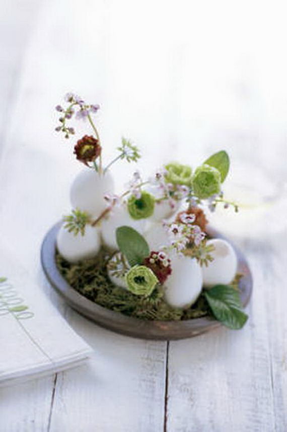 Lily of the valley and lisianthus in eggs on moss