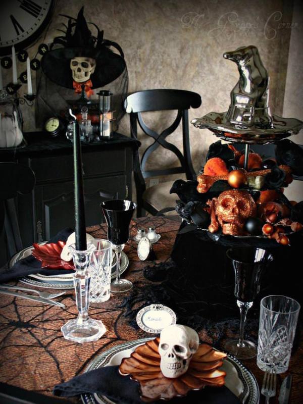 Black-and-orange-Halloween-table-setting-with-lots-of-skulls