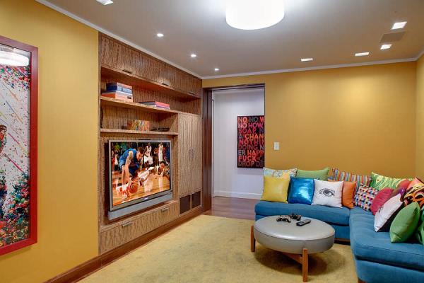 Bright-L-shaped-couch-in-blue-with-colorful-accent-pillows-for-the-TV-room