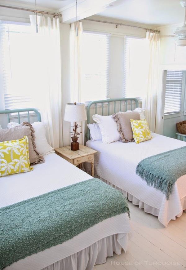 Bright-and-beach-themed-twin-beds-in-a-guest-room