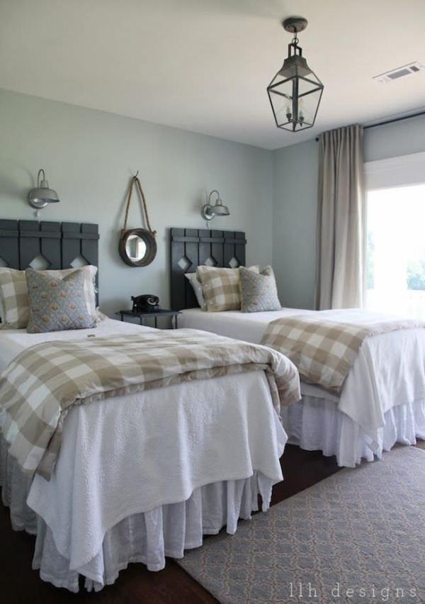 Country-guest-room-with-rustic-wood-head-boards-on-twin-beds