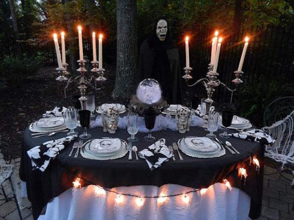 Outdoor-Halloween-table-setting-with-large-candlesticks