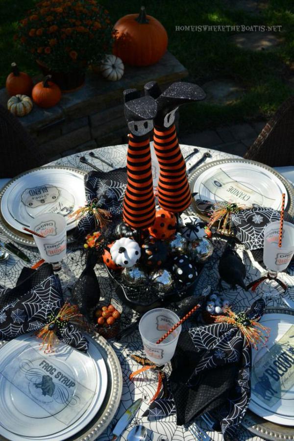 Outdoor-Halloween-table-setting-with-witchs-legs-centerpeice