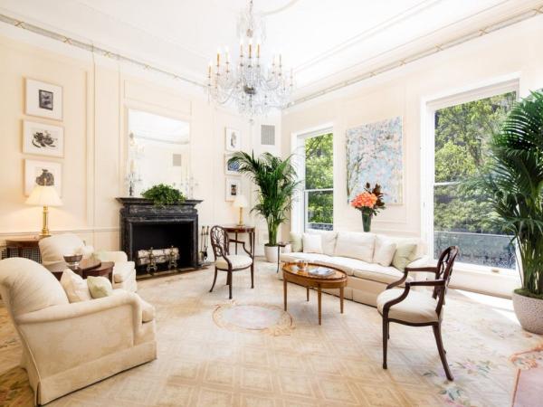 a-bright-and-sunny-solarium-provides-an-ideal-place-to-relax-with-views-of-the-backyard-greenery