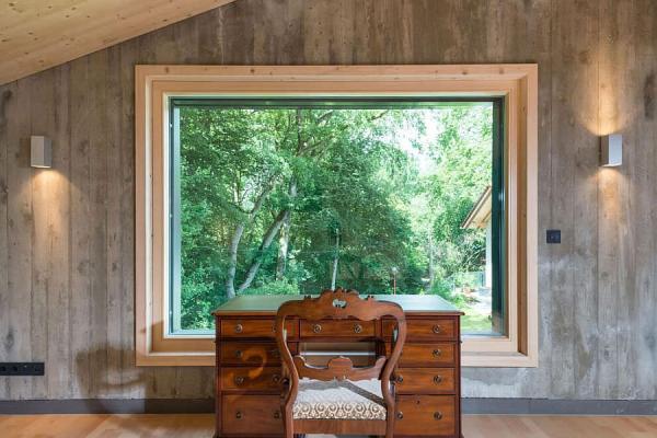 Home-workspace-with-a-classic-desk-and-chair-and-a-window-that-offers-panoramic-views