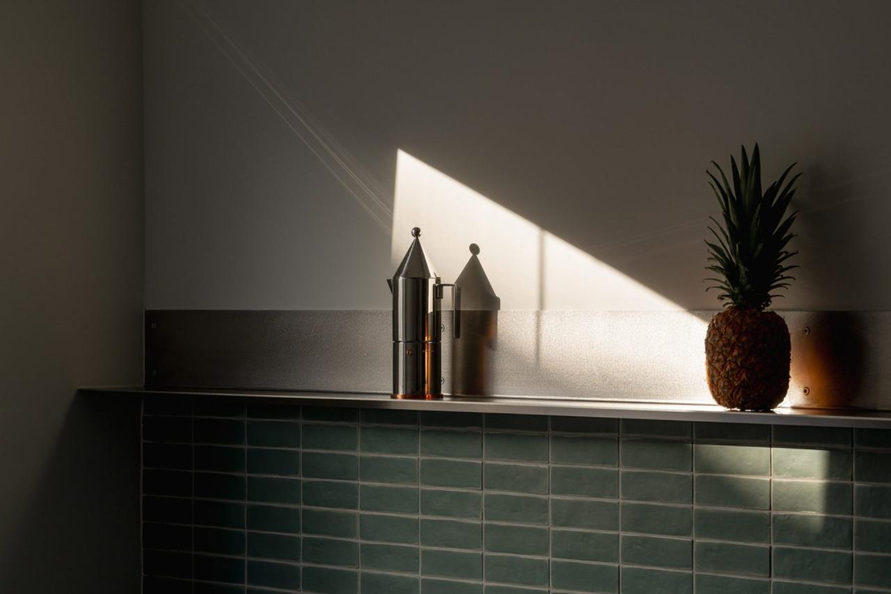 Detaliu blat bucatarie cu faianta verde-menta si cafetiera Alessi