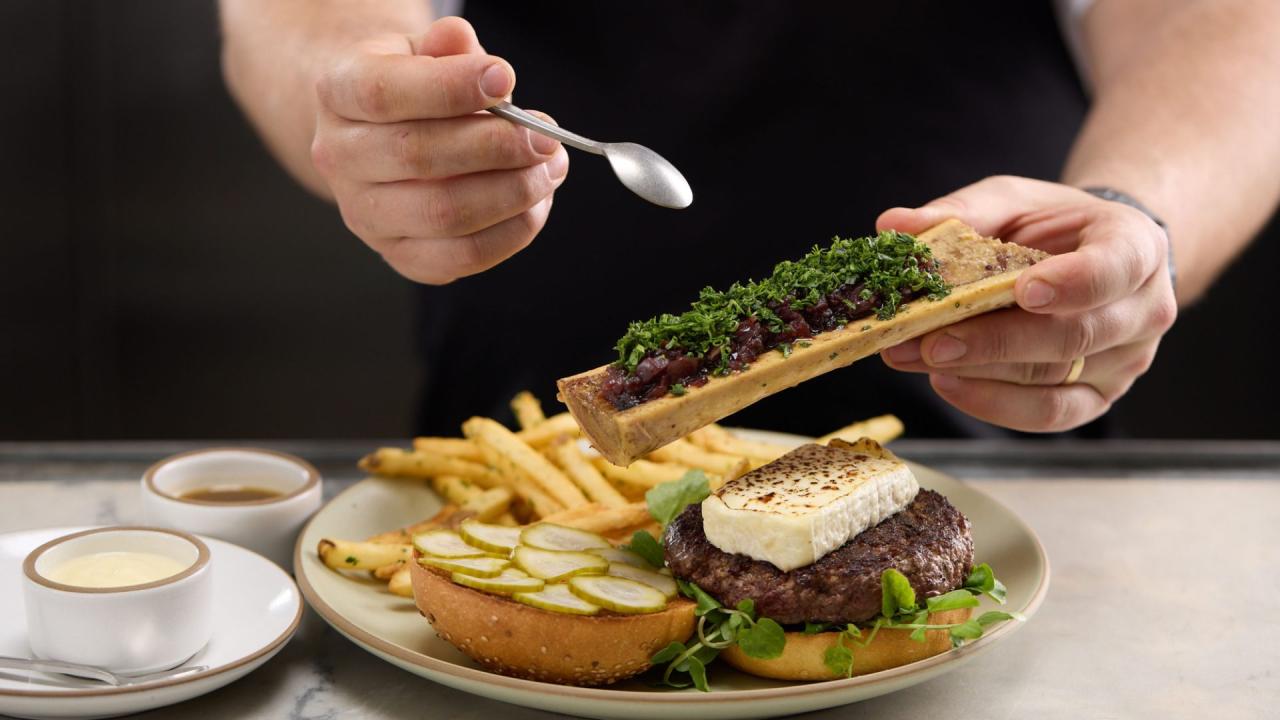 Proprietarul Jim Skånberg in spatiul Side A, cu zona de dining si perdelele din canvas crem care separa zonele