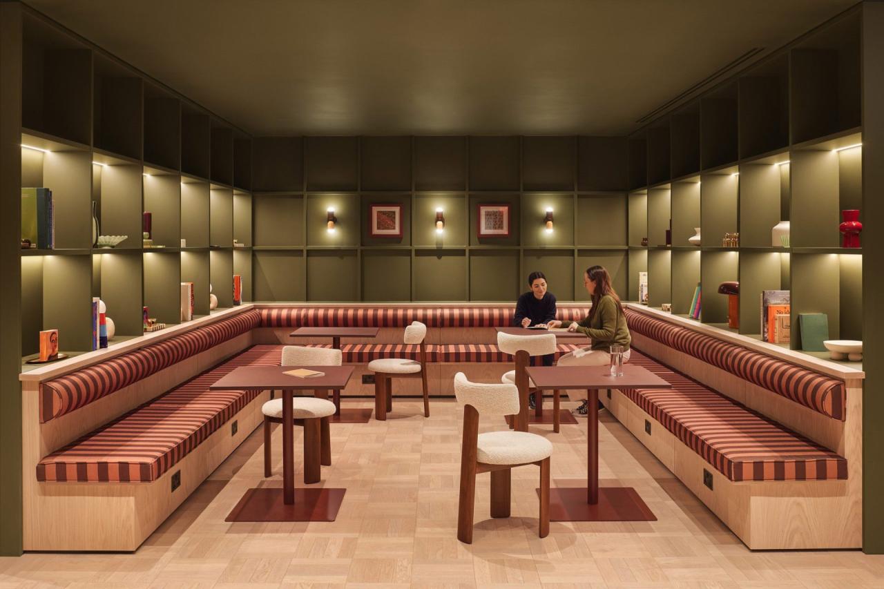 Zona de dining cu banchete tapitate in dungi rosii-maro si scaune albe