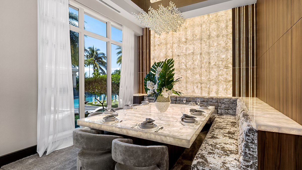 Breakfast nook cu masa din cuart alb, bancheta gri si vedere spre piscina