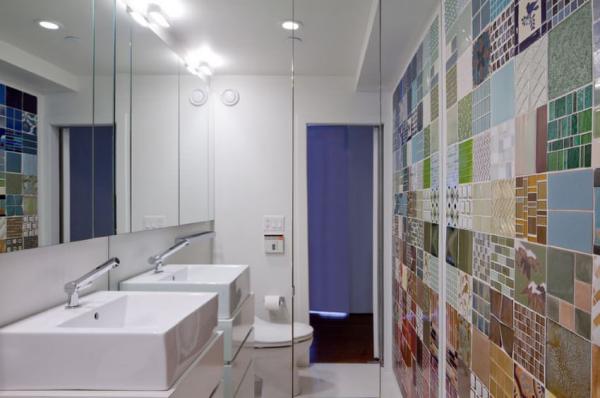 A-mirrored-wall-in-a-bathroom-with-colorful-tile