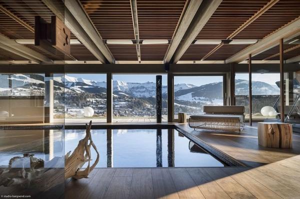 Expansive-indoor-pool-with-jet-streams-and-a-view-of-the-snow-covered-Alps