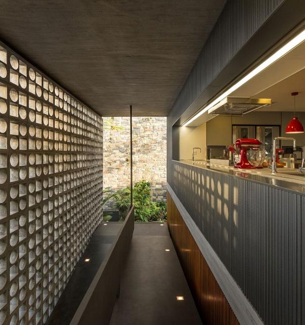 Hollowed-out-concrete-elements-allows-light-to-filter-through-into-the-kitchen