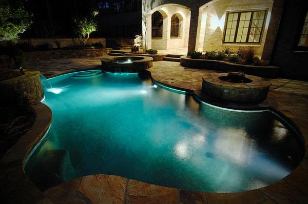 Ingenious-pool-with-twin-water-features-and-a-fire-pit