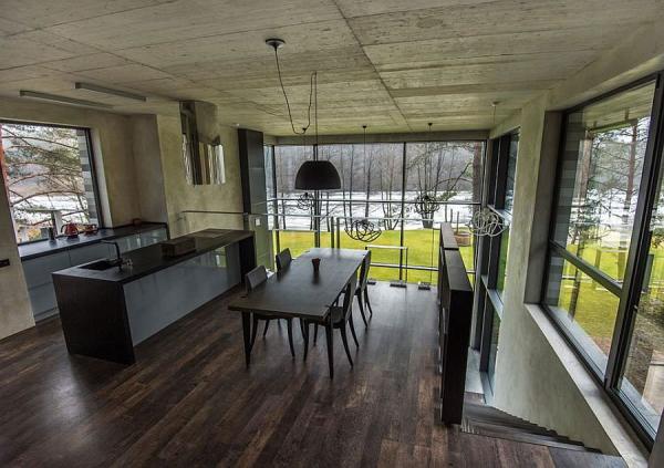 Kitchen-and-dining-area-overlooking-river-and-forest-landscape