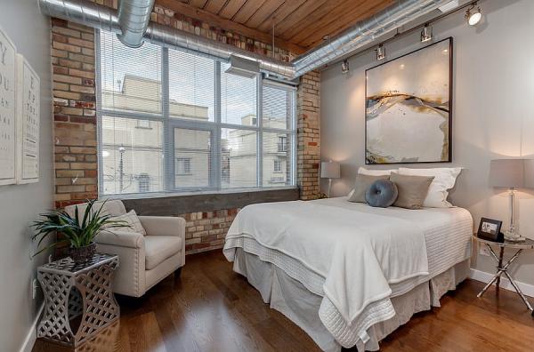 Modern-industrial-loft-bedroom-with-exposed-duct-work