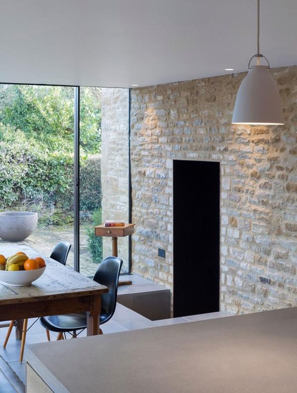 Original-stone-walls-act-as-the-backdrop-for-the-new-dining-space-and-kitchen