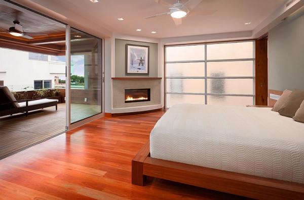 Sleek-corner-fireplace-adds-elegance-to-the-serene-bedroom