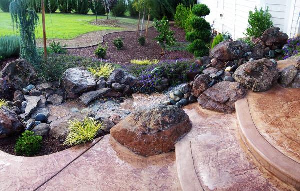 backyard-rock-stream-water-feature-stamped-concrete-stone-steps