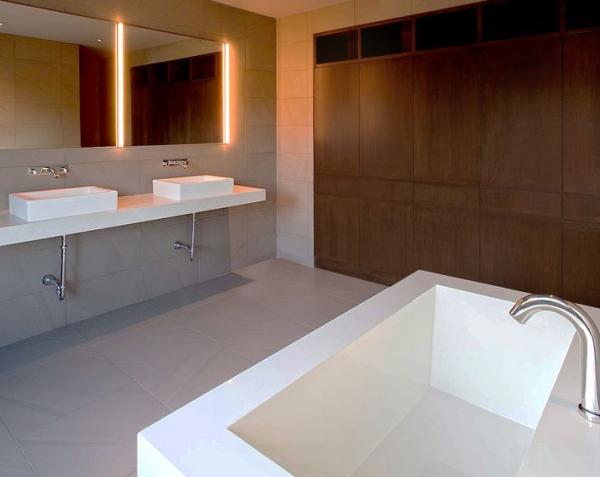 bathroom-featuring-a-mirror-with-lights-around
