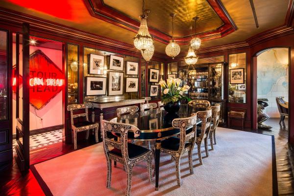 while-the-dining-room-is-lit-up-by-neon-and-gold-walls